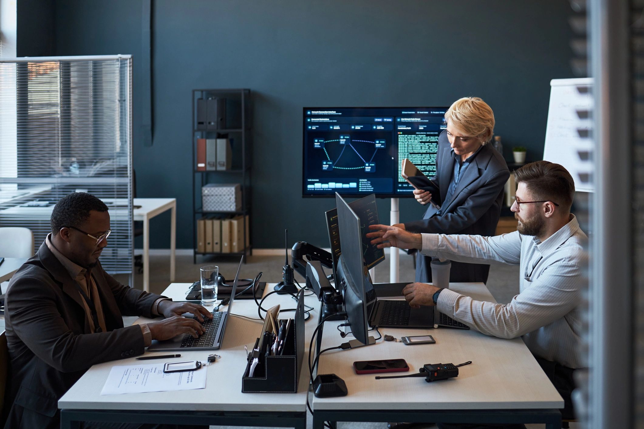 Diverse team reviewing information on office screens